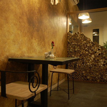 Photograph showing Table and Chair at pathayam raw food Restaurant.