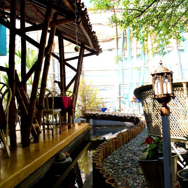 Photograph of Saarwa Cafe showing Bamboo Columns, Baamboo Roof & Waterbody